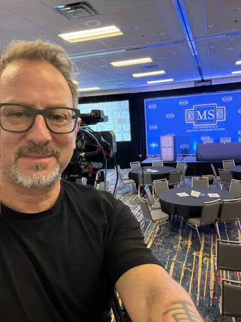 Sergio Myers beside a conference main-stage camera position