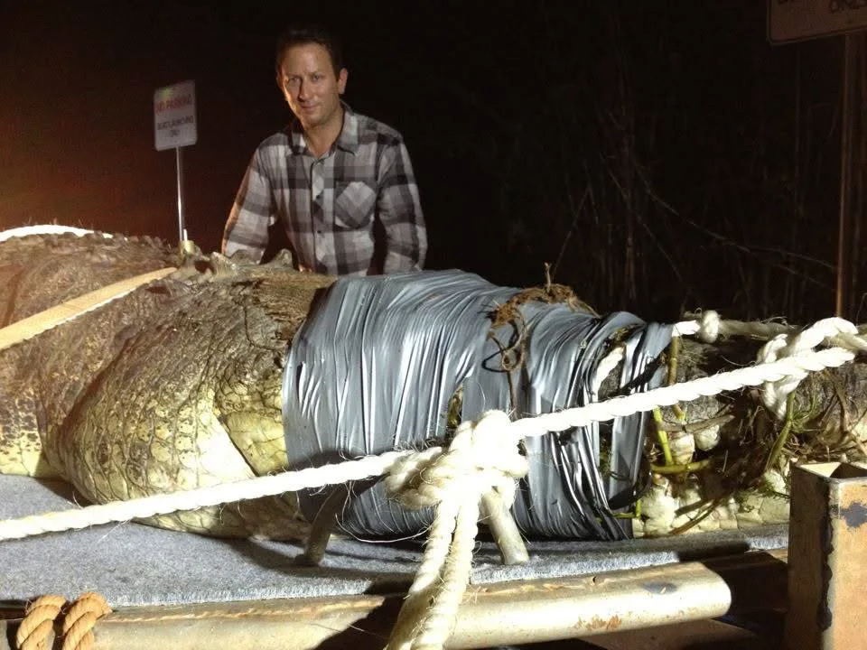 Sergio Myers beside a safely restrained crocodile during field production for Croc Catchers NT for National Geographic Australia