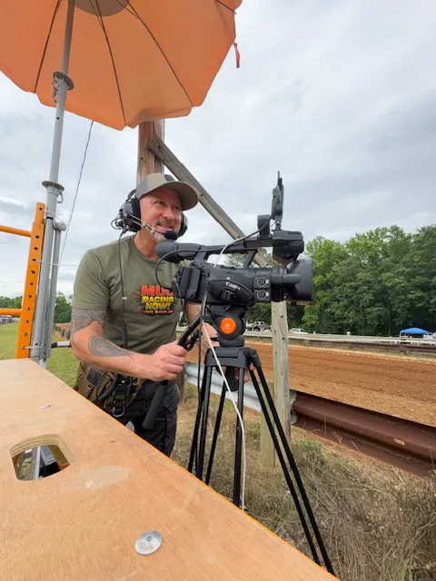 Sergio Myers operating a professional trackside camera during a Mud Racing Now live stream