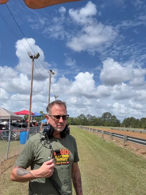 Sergio Myers carrying field audio equipment during an outdoor production